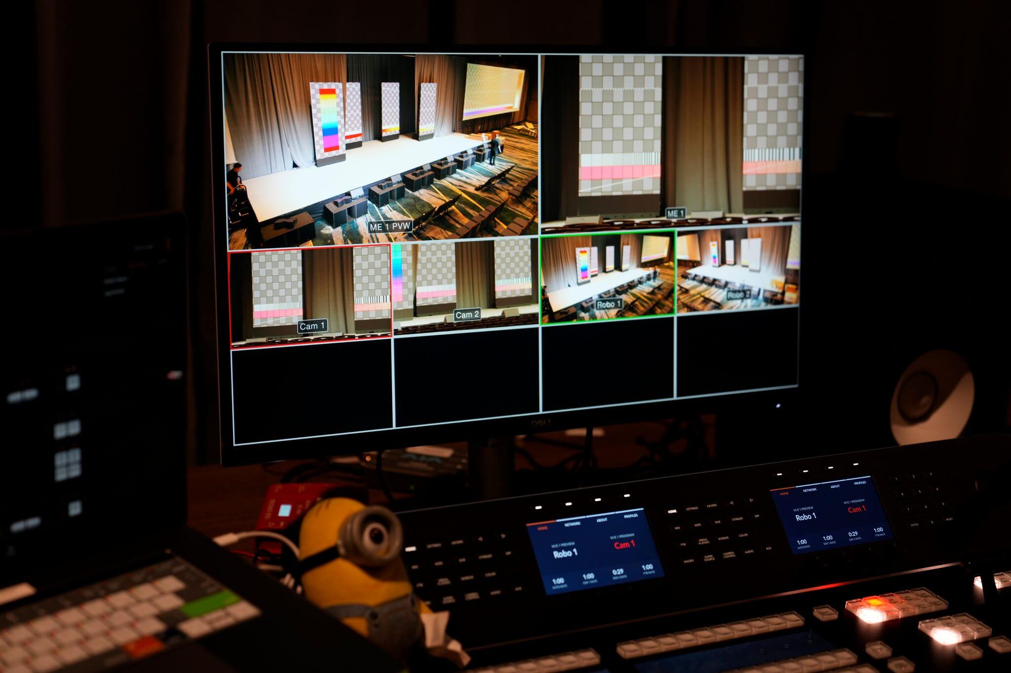 Behind a video monitor at an event.